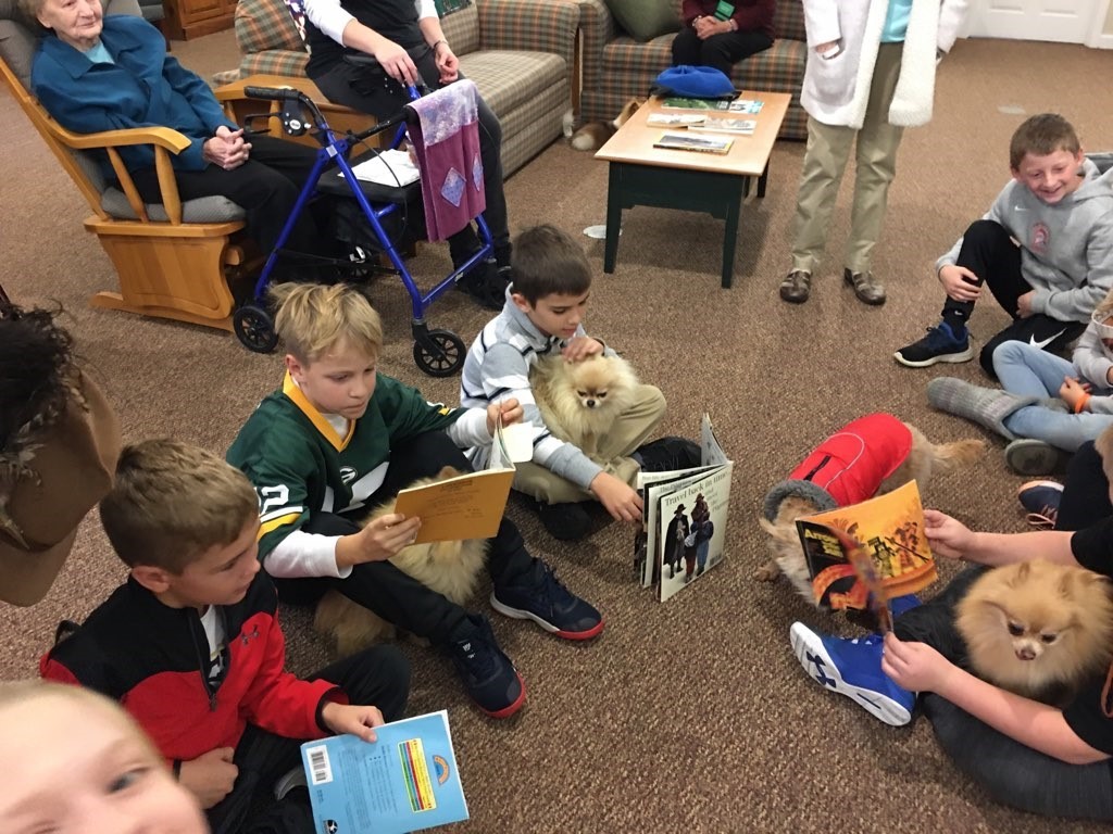 kids with books and dogs